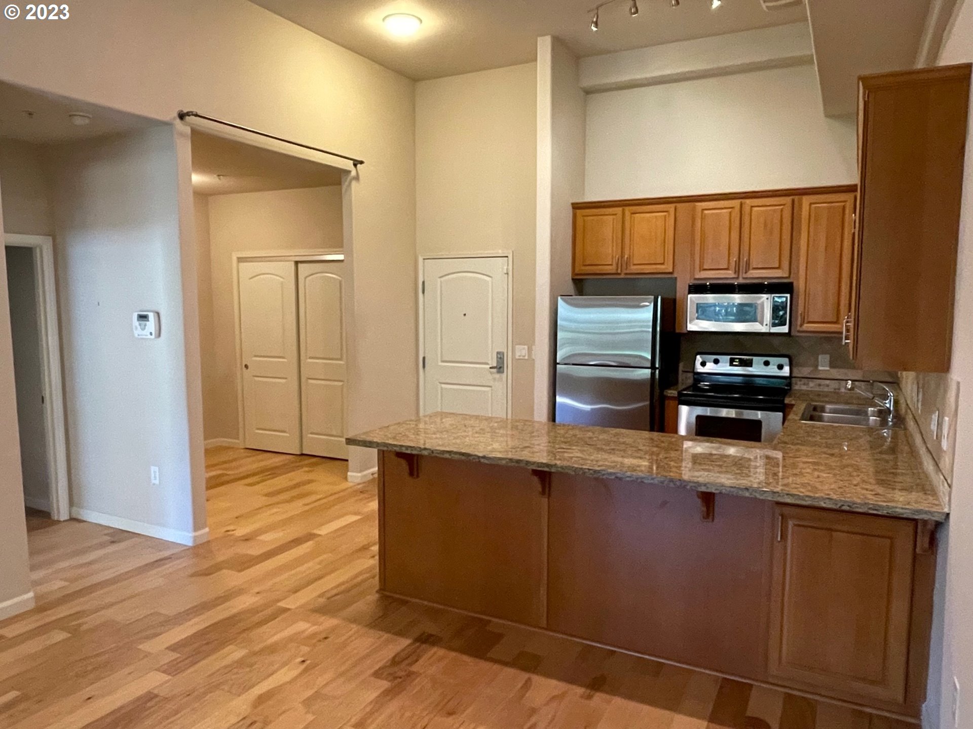 20512 Southwest Roy Rogers Road, Unit 112 Sherwood, OR 97140 - Photo 6 of 18 a kitchen with stainless steel appliances granite countertop a refrigerator and a stove