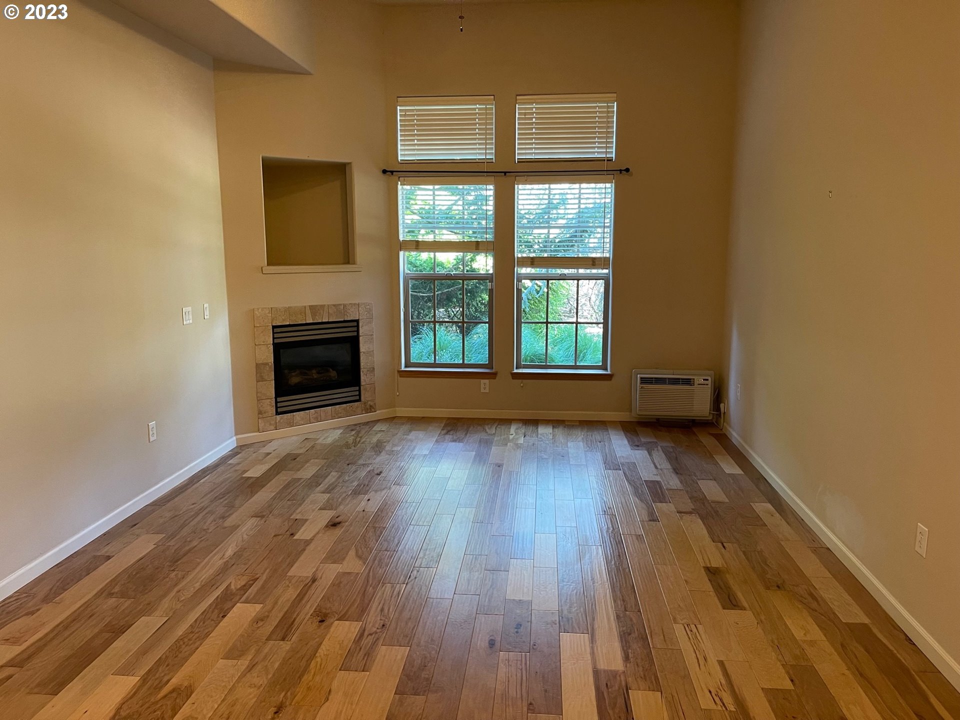 20512 Southwest Roy Rogers Road, Unit 112 Sherwood, OR 97140 - Photo 10 of 18 a view of empty room with wooden floor and fireplace