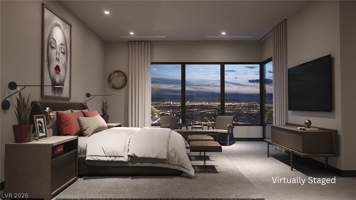 543 Overlook Rim Drive Henderson, NV 89012 - Photo 6 of 19 City lights twinkle beyond the expansive window in this inviting bedroom, offering a serene evening vista.