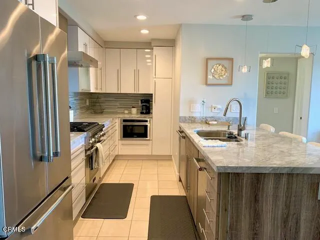 a kitchen with a sink stove and refrigerator