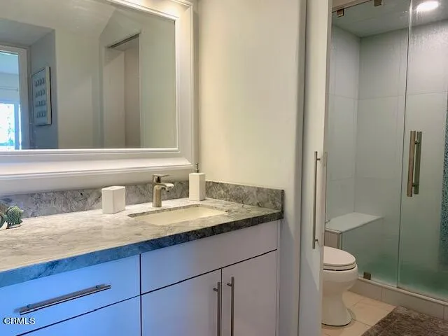 a bedroom with two beds and a dresser