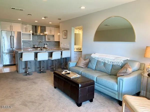 a living room with furniture and kitchen view