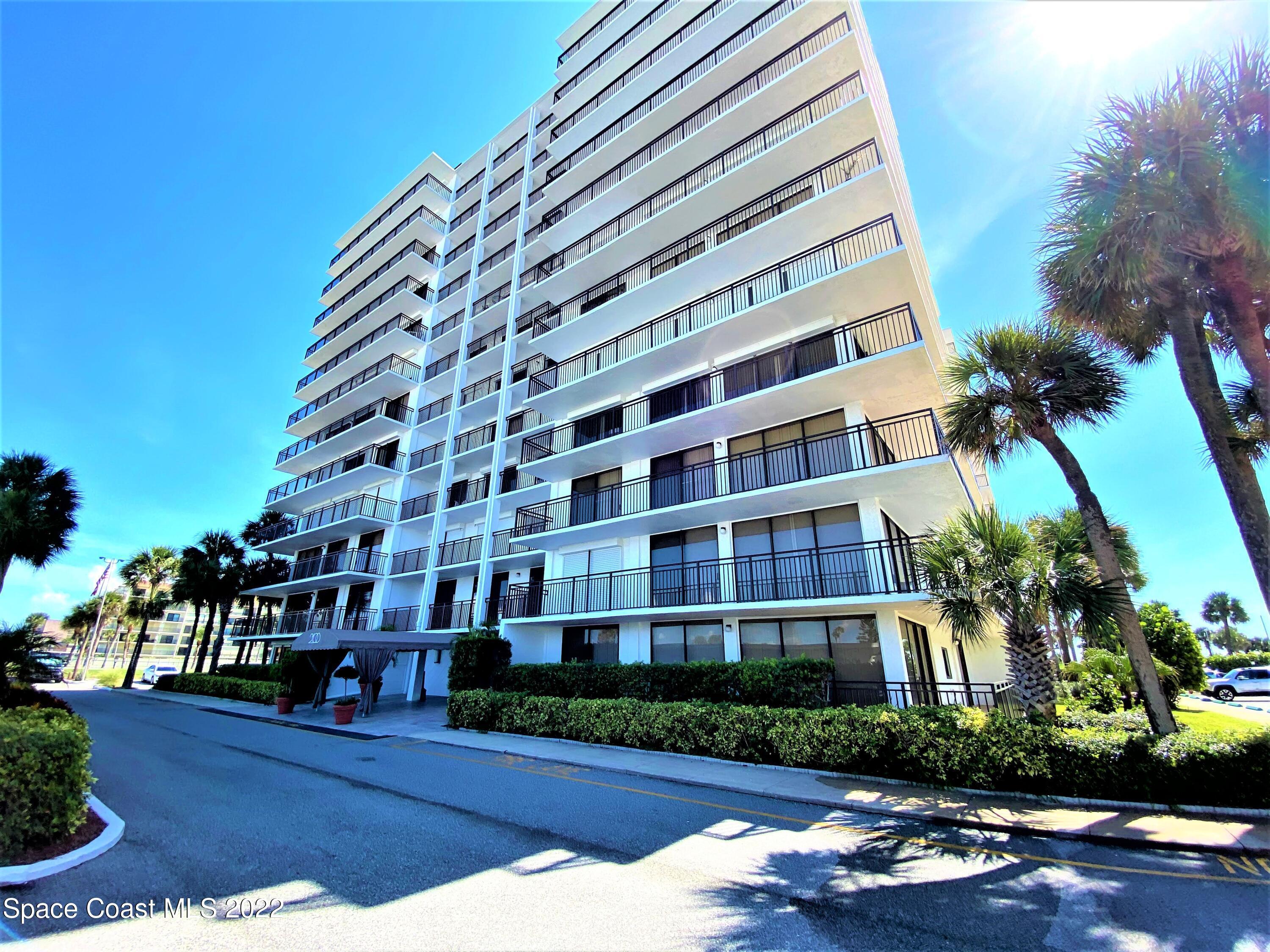 2100 North Atlantic Avenue, Unit 908 Cocoa Beach, FL 32931 - Photo 1 of 17 a view of a tall building next to a road