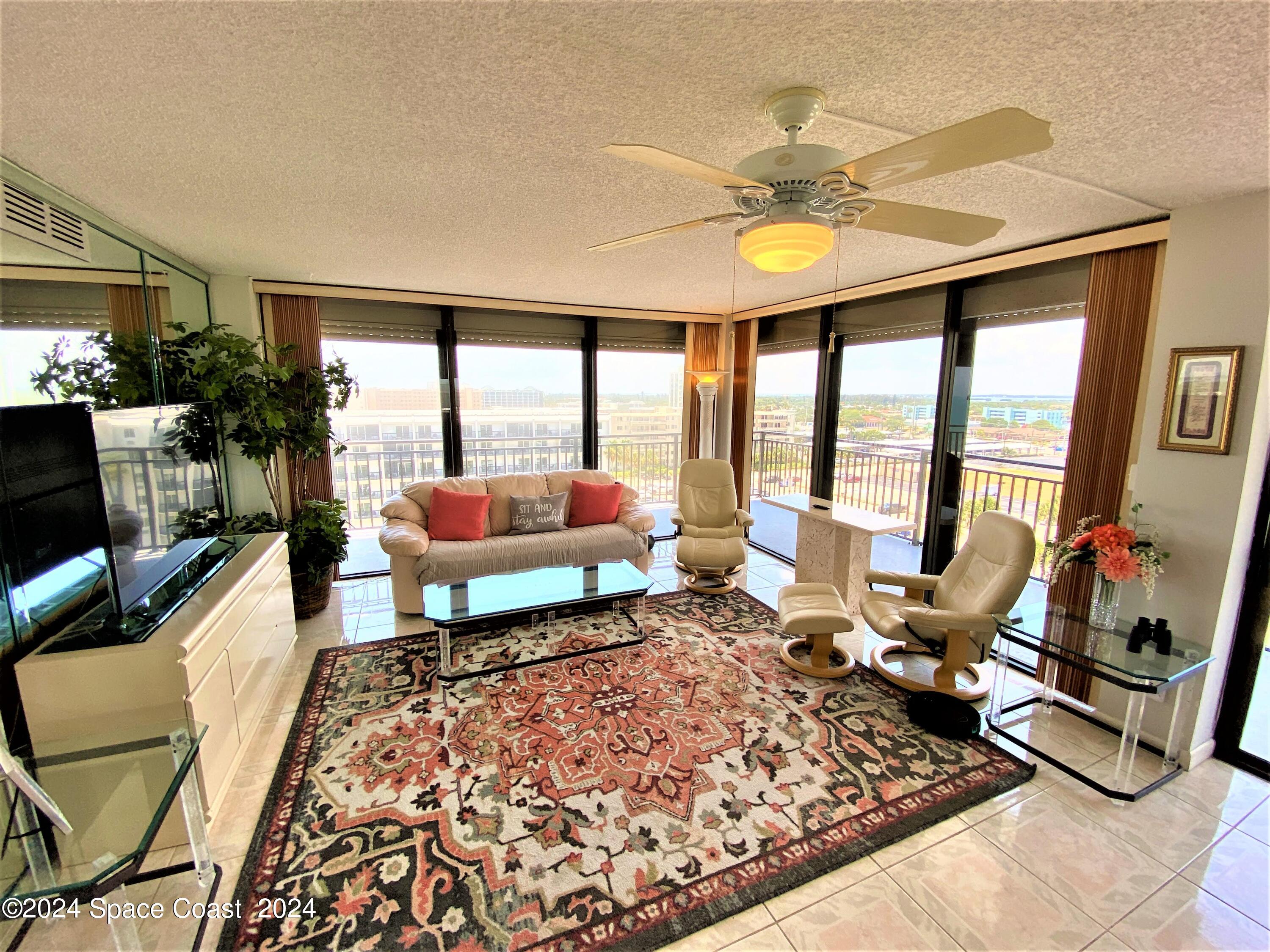 2100 North Atlantic Avenue, Unit 908 Cocoa Beach, FL 32931 - Photo 2 of 17 a living room with furniture and a large window