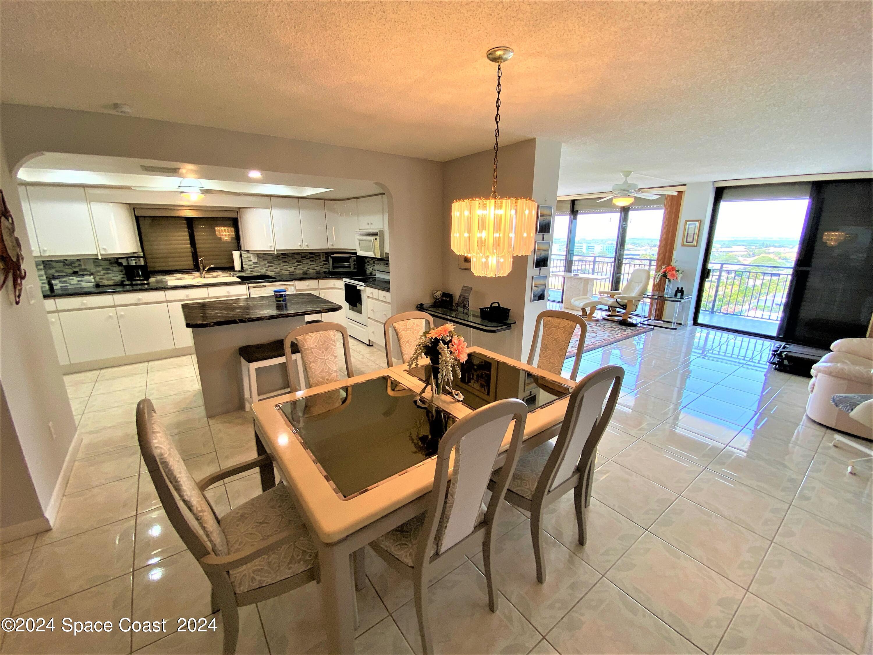 2100 North Atlantic Avenue, Unit 908 Cocoa Beach, FL 32931 - Photo 4 of 17 a view of a dining room with furniture