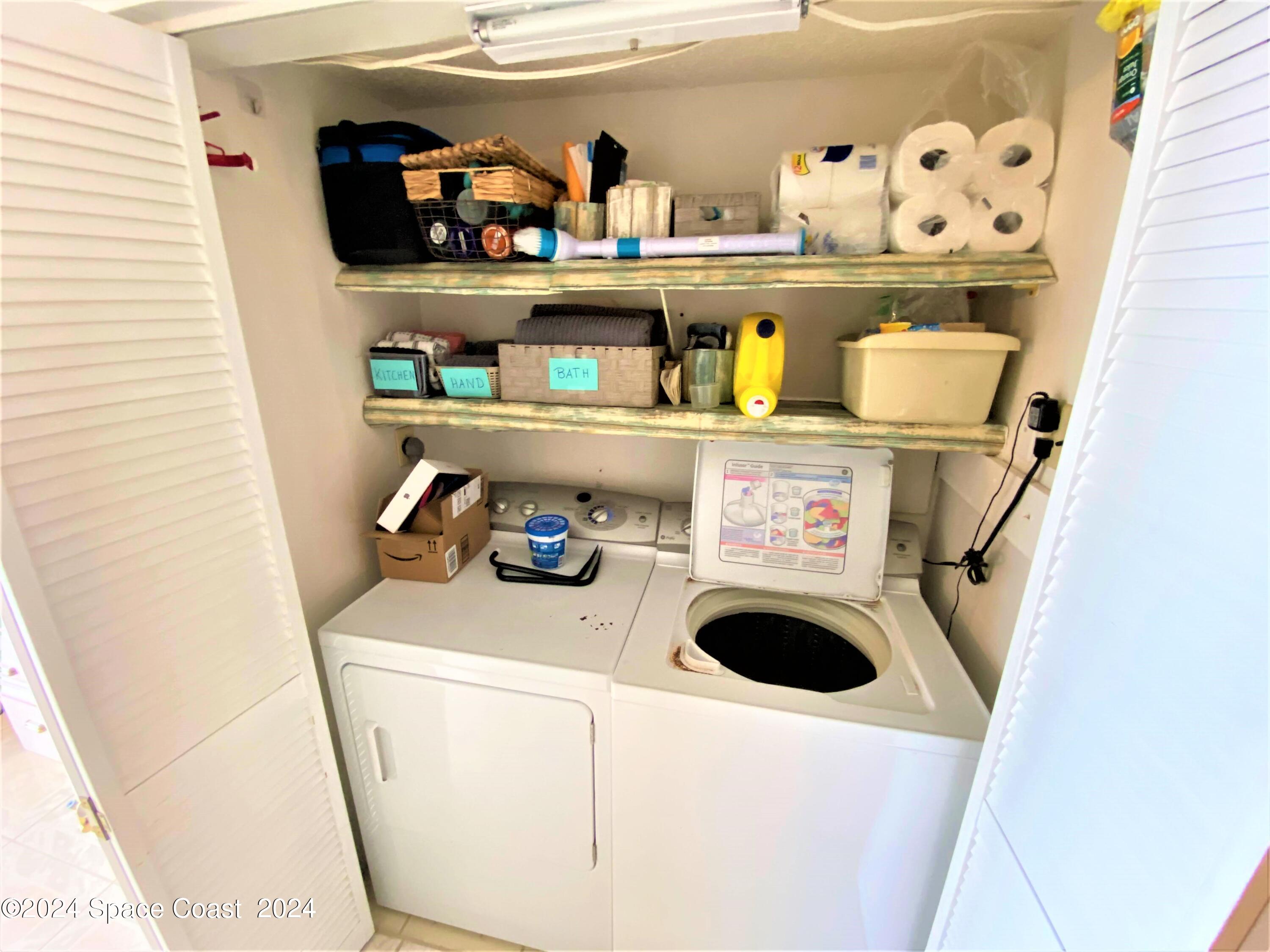2100 North Atlantic Avenue, Unit 908 Cocoa Beach, FL 32931 - Photo 6 of 17 a utility room with dryer and washer