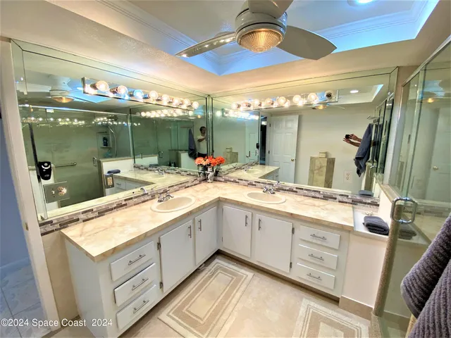 a bathroom with a sink double vanity and a mirror