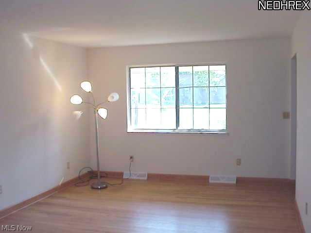 9037 Root Road North Ridgeville, OH 44039 - Photo 3 of 18 Spacious living room offers wood flooring (all wood floors were refinished in 7/2011) and light welcoming windows.