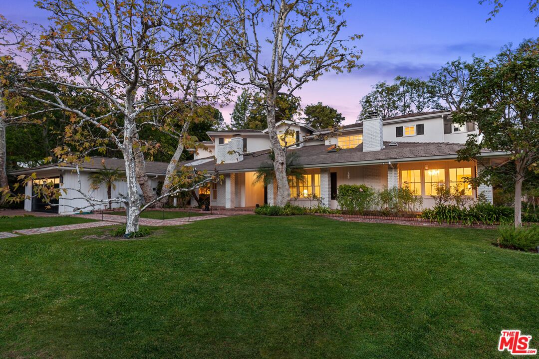 15475 Milldale Drive Los Angeles, CA 90077 - Photo 2 of 22 a front view of a house with a garden