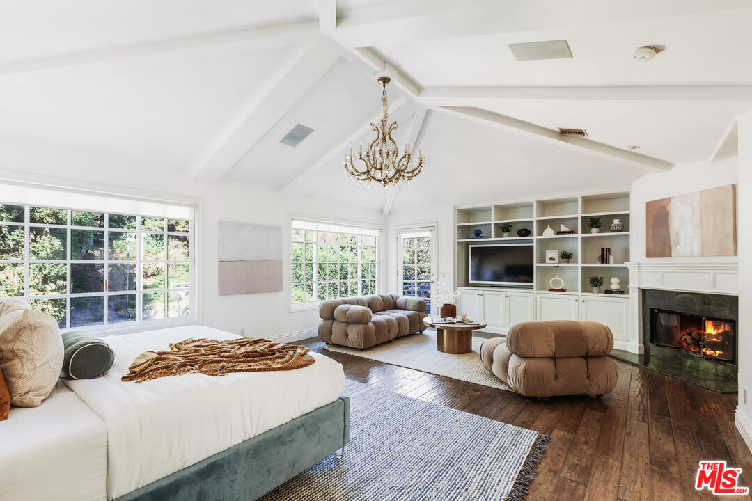 15475 Milldale Drive Los Angeles, CA 90077 - Photo 14 of 22 a bedroom with a bed and wooden floor