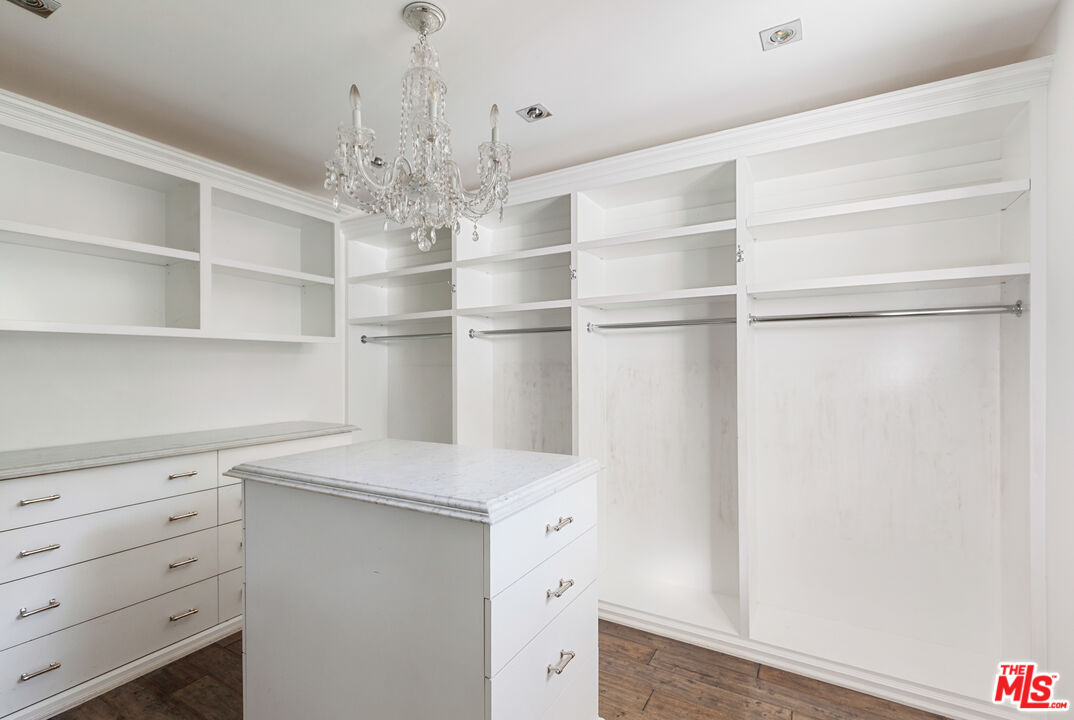 15475 Milldale Drive Los Angeles, CA 90077 - Photo 15 of 22 a kitchen with a white cabinets and chandelier