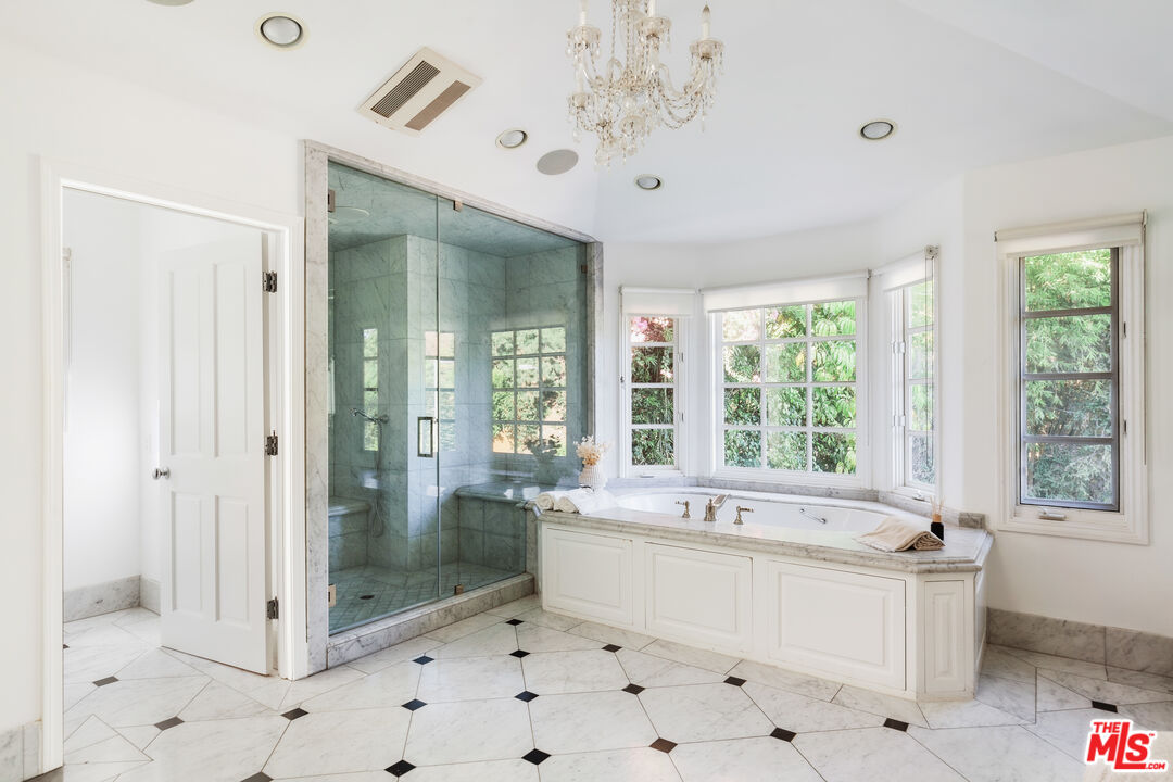 15475 Milldale Drive Los Angeles, CA 90077 - Photo 16 of 22 a bathroom with a bathtub sink and large window