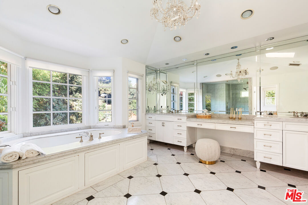 15475 Milldale Drive Los Angeles, CA 90077 - Photo 17 of 22 a large white bathroom with a large window bathtub and sink
