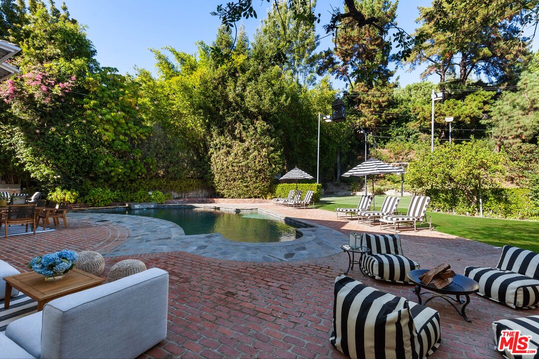15475 Milldale Drive Los Angeles, CA 90077 - Photo 20 of 22 a view of a patio with couches table and chairs and potted plants