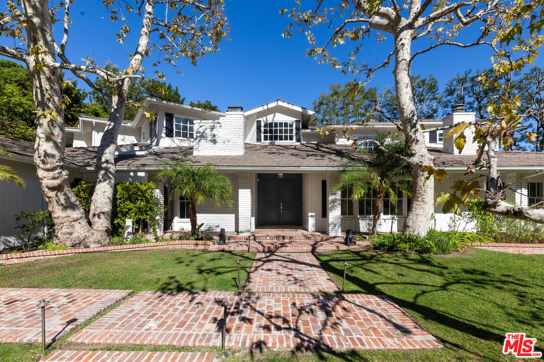 15475 Milldale Drive Los Angeles, CA 90077 - Photo 3 of 22 a front view of a house with a garden