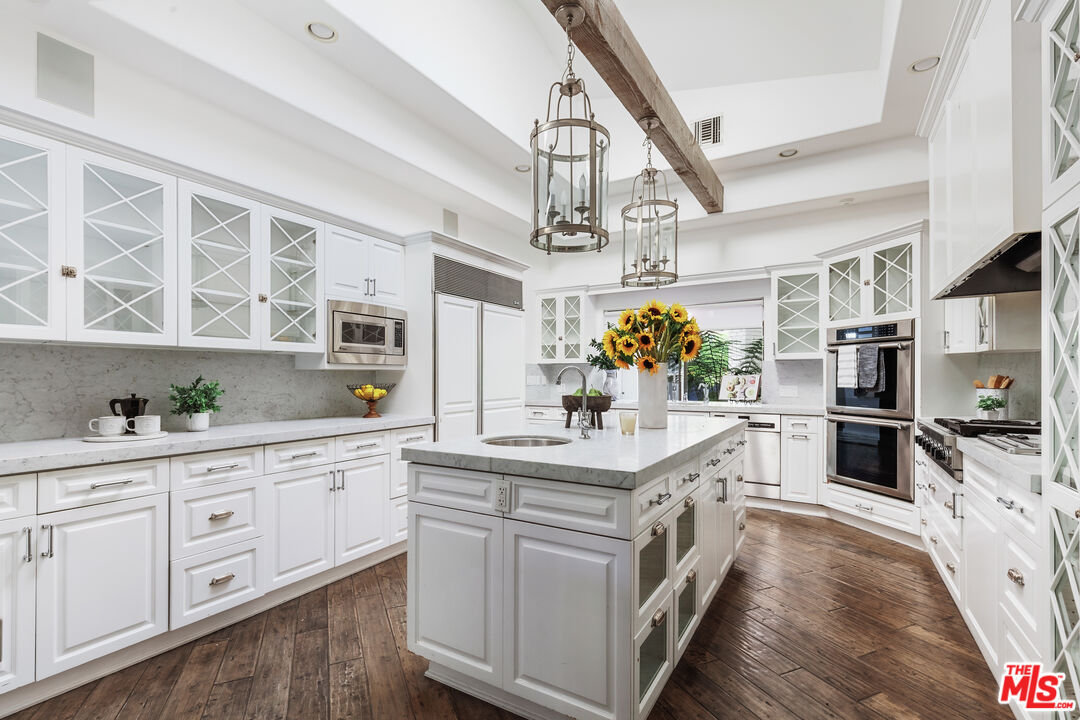 15475 Milldale Drive Los Angeles, CA 90077 - Photo 7 of 22 a kitchen with stainless steel appliances a sink and a stove