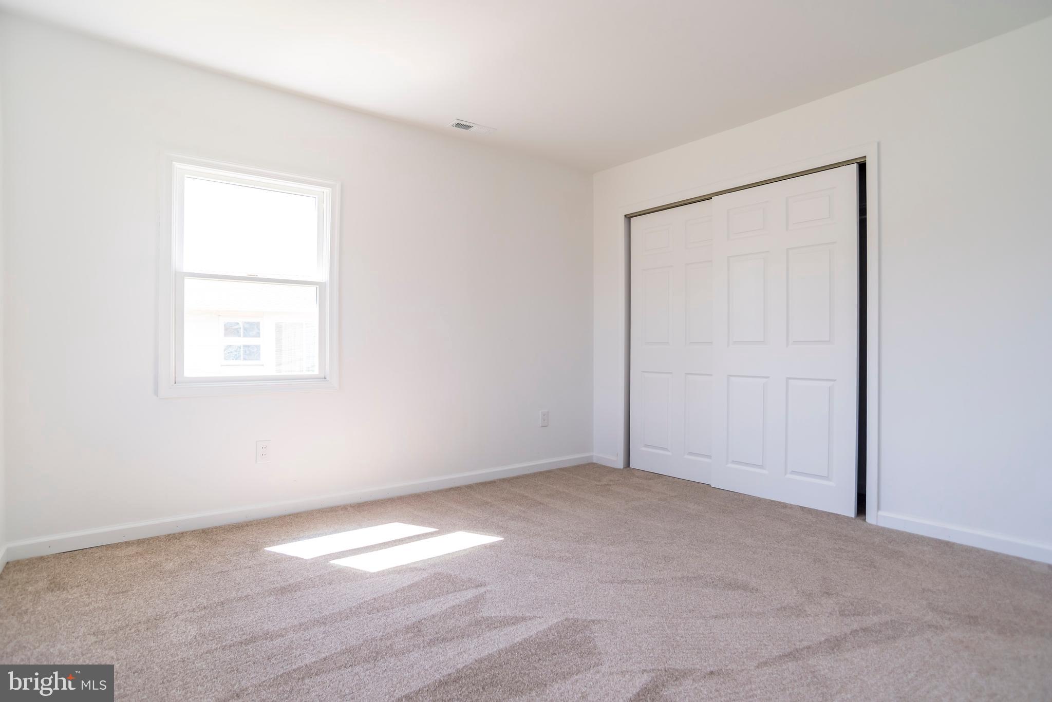 44 Elm Lane Levittown, PA 19054 - Photo 23 of 35 an empty room with a wooden door
