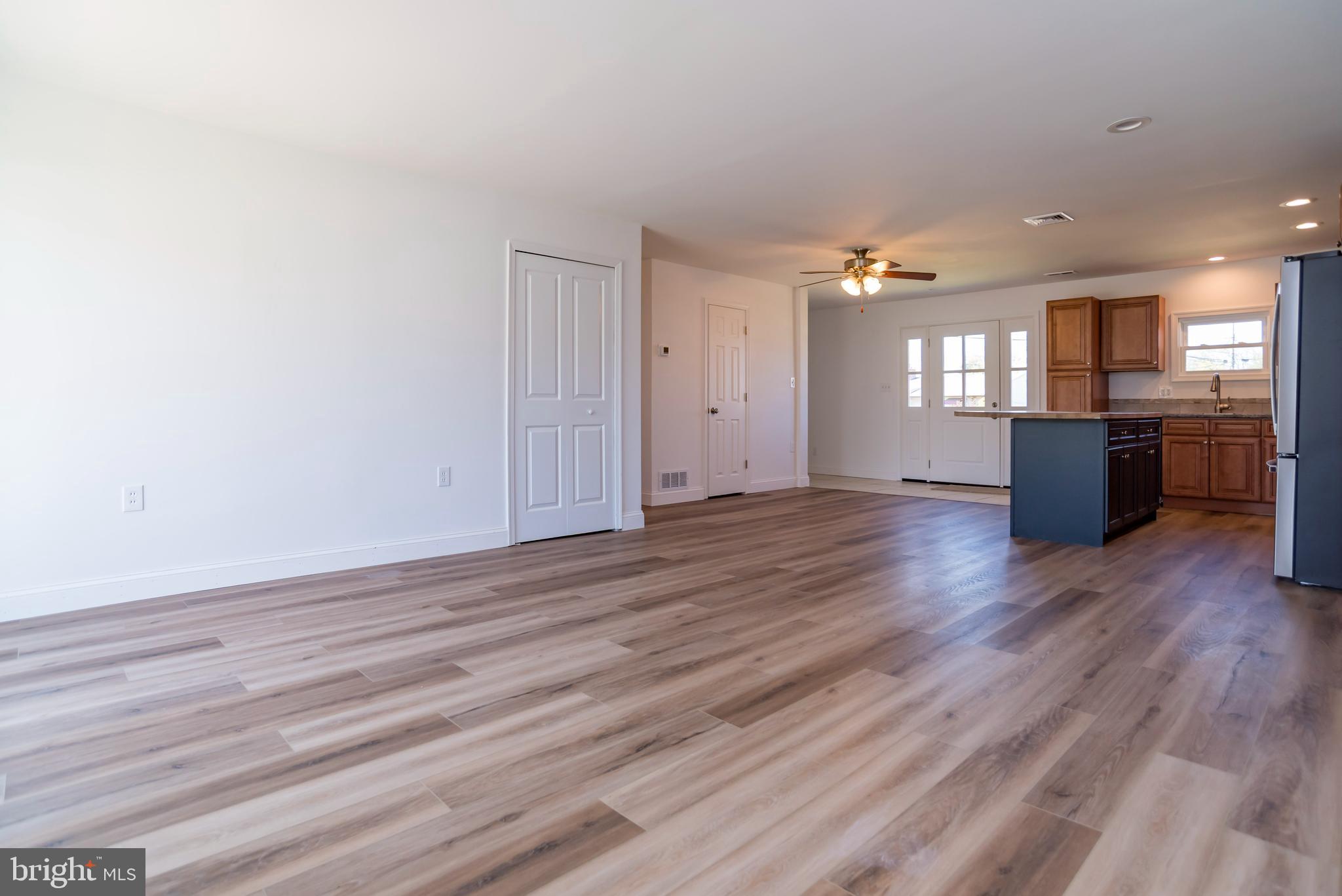 44 Elm Lane Levittown, PA 19054 - Photo 6 of 35 an empty room with wooden floor and windows