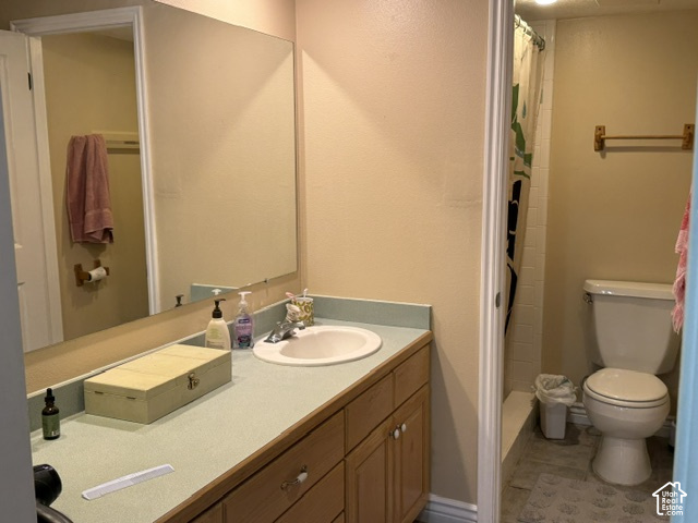 1541 North Riverside Avenue West, Unit 18 Provo, UT 84604 - Photo 7 of 8 Bathroom featuring a wood-finish vanity with a single basin sink and a large wall-mounted mirror