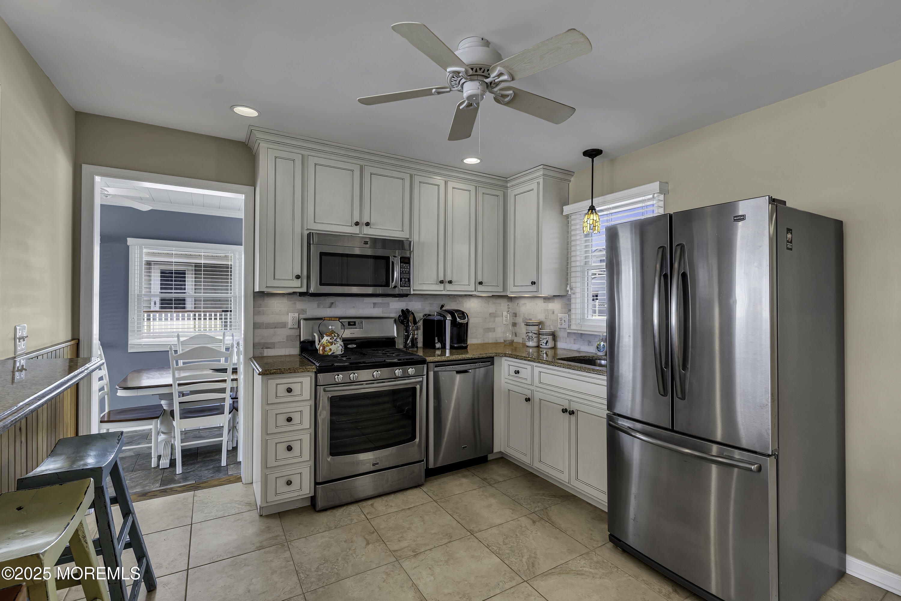 5 Dover Avenue Lavallette, NJ 08735 - Photo 7 of 21 a kitchen with stainless steel appliances granite countertop a refrigerator a stove a sink and a microwave