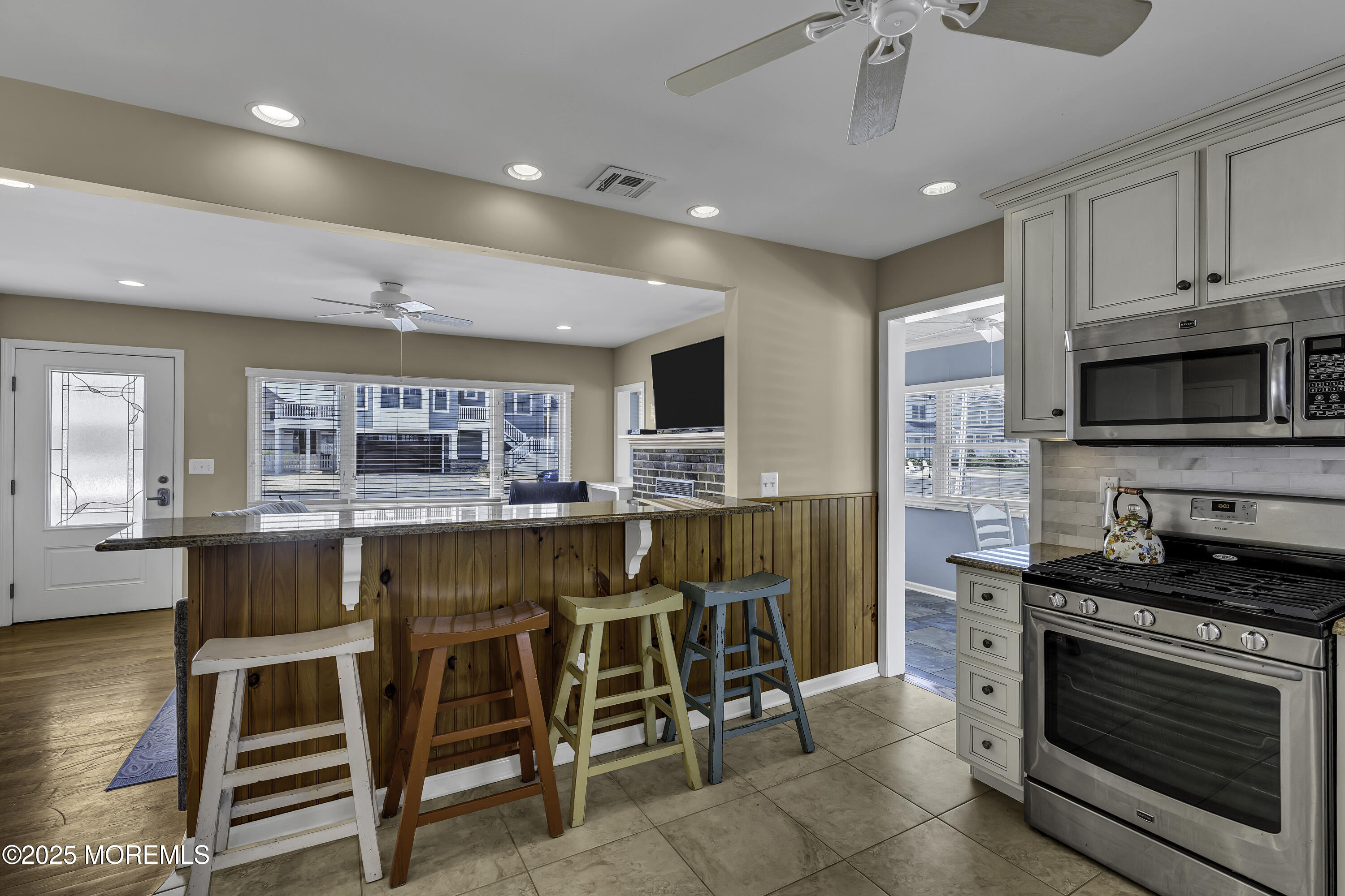 5 Dover Avenue Lavallette, NJ 08735 - Photo 9 of 21 a kitchen with stainless steel appliances kitchen island granite countertop a stove top oven a sink and a refrigerator