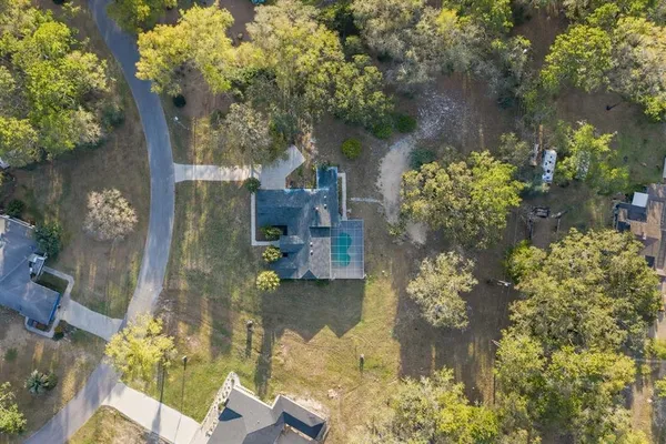 a aerial view of a house with a yard basket ball court and outdoor seating
