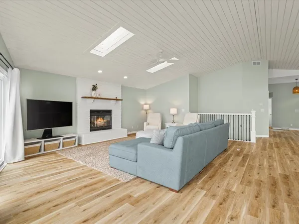 a bedroom with a large bed and ceiling fan