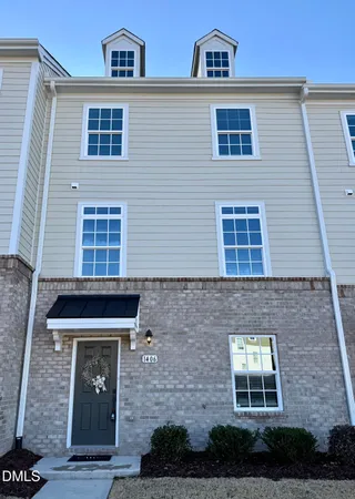 a front view of a house with plants