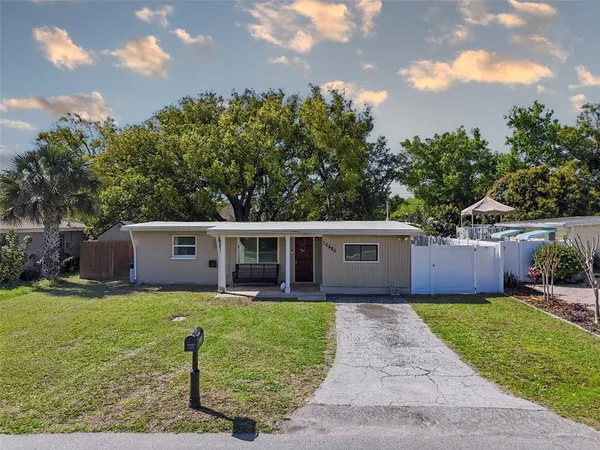 a view of a house with a yard and sitting area