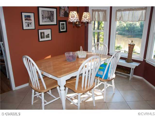 10409 White Rabbit Road North Chesterfield, VA 23235 - Photo 7 of 23 a view of a dining room with furniture a chandelier and wooden floor