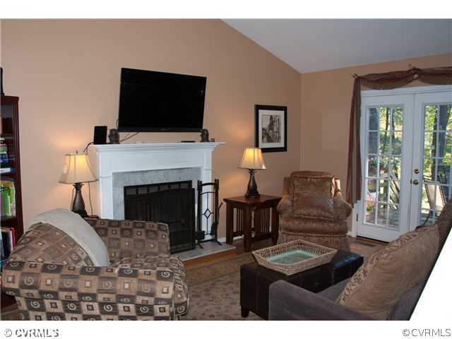 10409 White Rabbit Road North Chesterfield, VA 23235 - Photo 10 of 23 a living room with furniture a flat screen tv and a fireplace