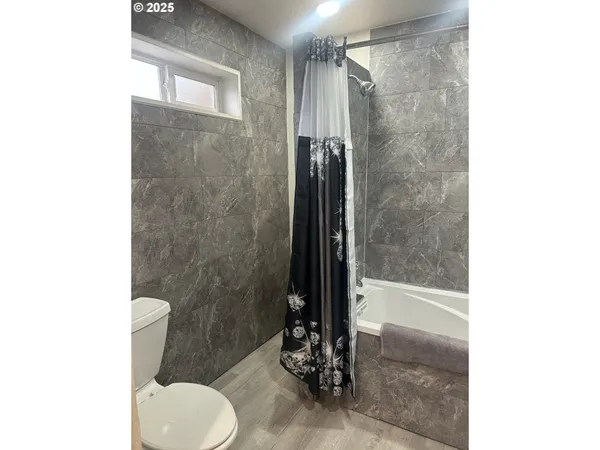 a bathroom with a shower and a toilet