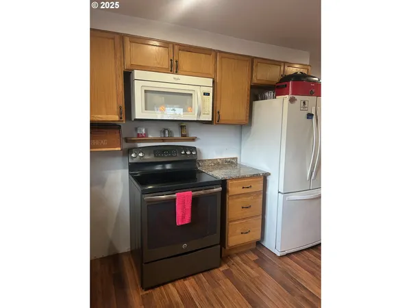 a kitchen with stainless steel appliances a stove and a microwave