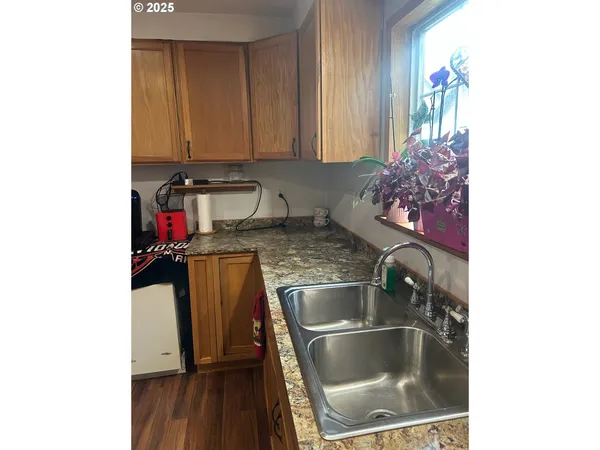 a kitchen with a sink and a stove top oven