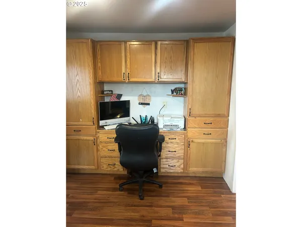 a view of a workspace with furniture and a window