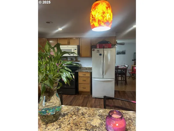 a kitchen with a refrigerator and a stove