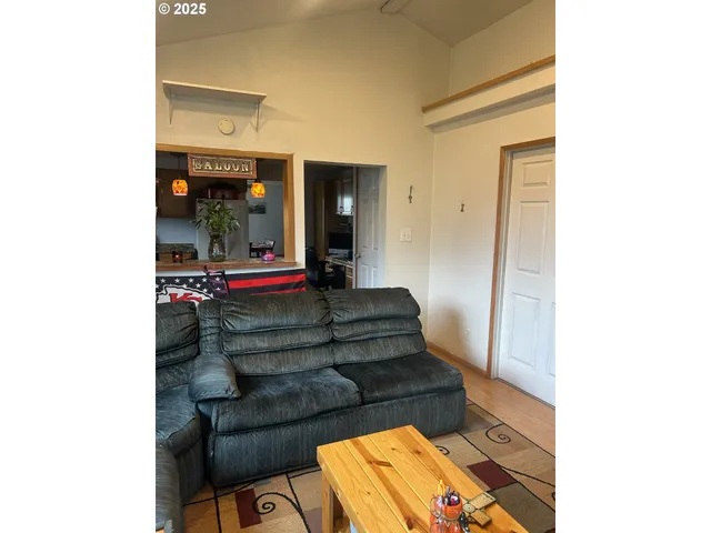 a living room with furniture and a mirror
