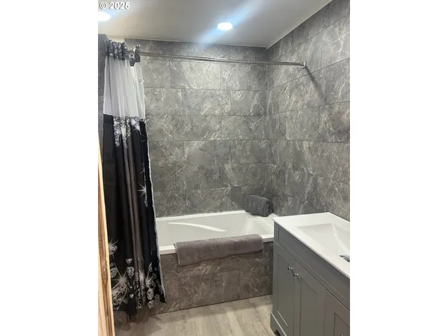a bathroom with a bathtub and shower