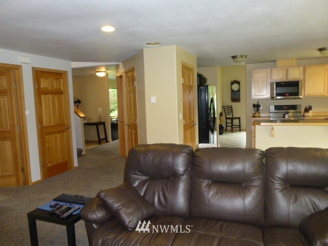 556 Gasman Road Port Angeles, WA 98362 - Photo 14 of 19 a living room with furniture and a flat screen tv