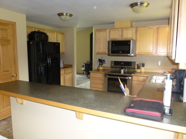 556 Gasman Road Port Angeles, WA 98362 - Photo 3 of 19 a kitchen with stainless steel appliances granite countertop a refrigerator a stove top oven a sink and dishwasher