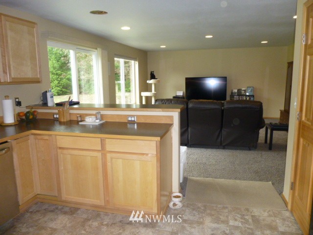 556 Gasman Road Port Angeles, WA 98362 - Photo 4 of 19 a kitchen with a sink a stove and cabinets