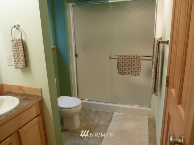 556 Gasman Road Port Angeles, WA 98362 - Photo 8 of 19 a bathroom with a granite countertop sink toilet and a mirror