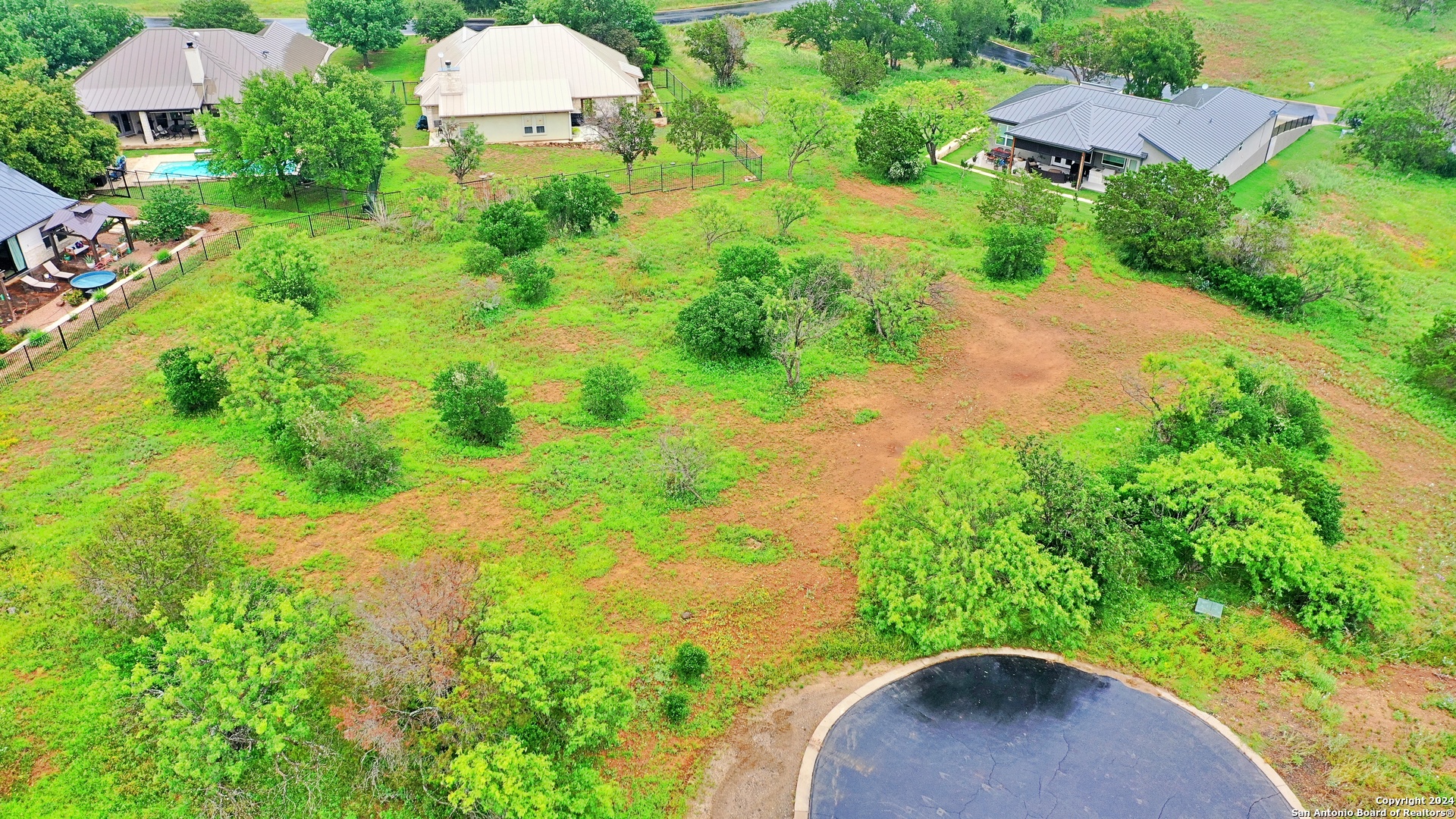 108 Mountain Home Road Horseshoe Bay, TX 78657 - Photo 2 of 22 an aerial view of a house with a yard and lake view