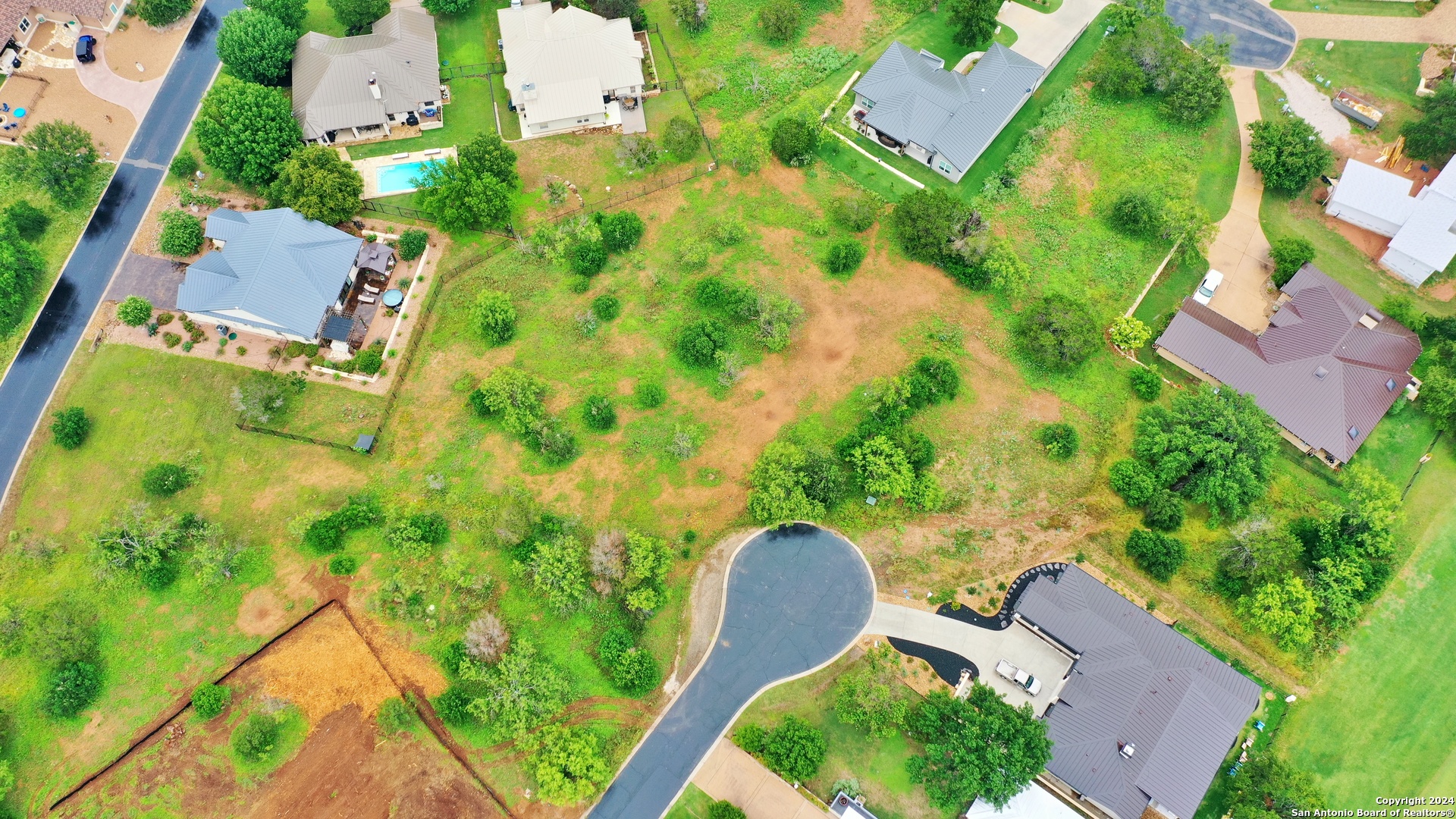 108 Mountain Home Road Horseshoe Bay, TX 78657 - Photo 3 of 22 an aerial view of a house with garden space and street view