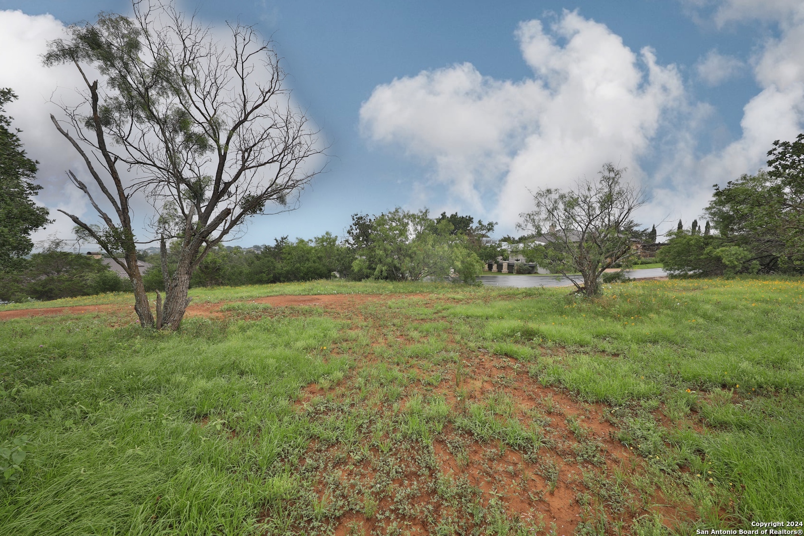 108 Mountain Home Road Horseshoe Bay, TX 78657 - Photo 7 of 22 a big yard with lots of green space and plants