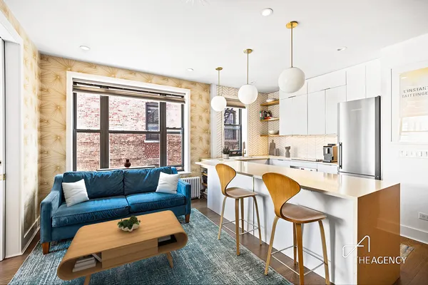 a living room with furniture a flat screen tv and floor to ceiling window