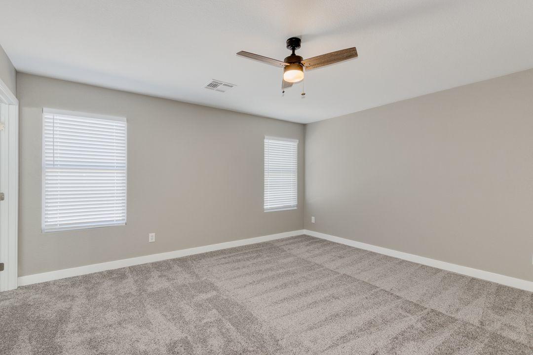 11514 West Larkspur Road El Mirage, AZ 85335 - Photo 14 of 20 a view of a livingroom with a ceiling fan and window