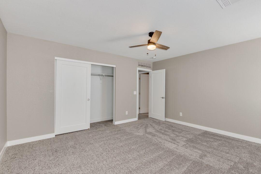 11514 West Larkspur Road El Mirage, AZ 85335 - Photo 15 of 20 a view of an empty room with a fan