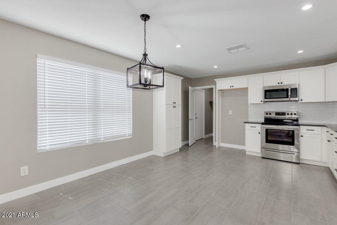 11514 West Larkspur Road El Mirage, AZ 85335 - Photo 7 of 20 a view of a kitchen with microwave and stove
