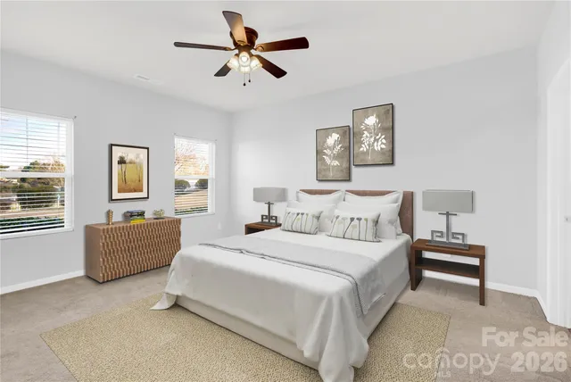 a bedroom with a bed chandelier and window